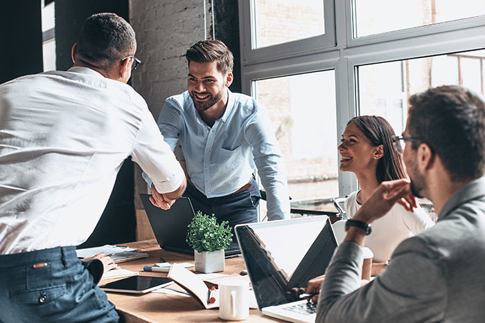 team of young business professionals sitting around a table